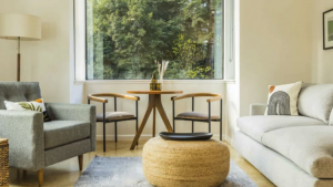 In the living room at Mendocino Inn, a large window offers a view of the surrounding trees.